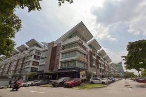 a large building with cars parked in a parking lot at SMC Hotel Seksyen 13 in Shah Alam