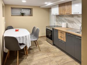 a kitchen with a table and chairs and a kitchen with a sink at BS Brother in Ruse