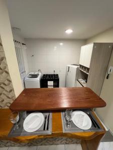 a small kitchen with a table with plates on it at Apartamento in Campo Largo