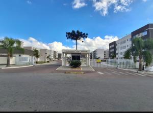 a building with a tree in the middle of a street at Apartamento in Campo Largo