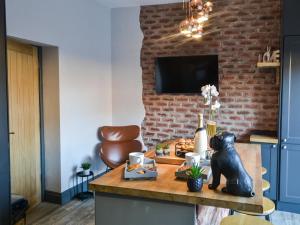 a room with a table with a bear statue on it at Copper Cottage in Morpeth