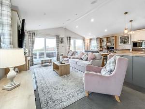 a living room with a couch and a table at Turnberry Lodge in Girvan