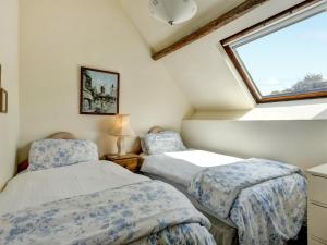 two beds in a room with a window at Bossington- Ukc4921 in Timberscombe