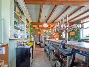 a kitchen with a long counter in a room at Alderfalls - Exclusive Private Pub Experience in Coelbren +20 photos