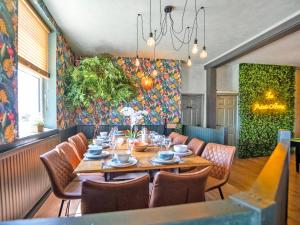 a dining room with a table and chairs at Alderfalls - Exclusive Private Pub Experience in Coelbren