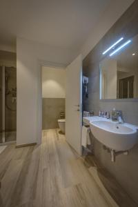 a bathroom with a white sink and a toilet at Arli Hotel Hideaway Punta Ala - Adults Only in Punta Ala