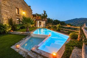 a swimming pool in the yard of a house at Casa Love Story - Piscina, Sauna & Jacuzzi in Arcos de Valdevez