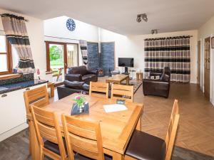 a dining room and living room with a table and chairs at One Eden Cottage - Ukc6253 in Linlithgow