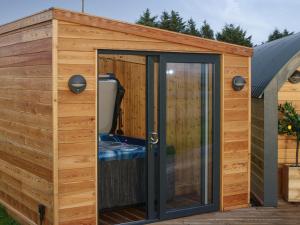 a wooden garden room with a sliding glass door at Ben Aigan - Ukc6027 in Newmill