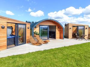 a circular house with chairs on a deck at Ben Aigan - Ukc6027 in Newmill