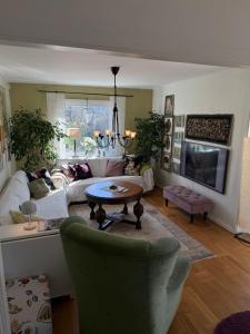 a living room with a couch and a table at Bo nära strand och city. in Västra Frölunda