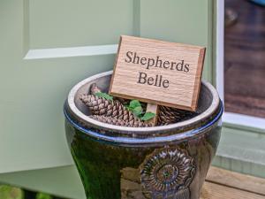 a wooden sign in a flower pot with a sign that reads strengths bell at Shepherds Belle & Croft Hut - Qu7633 in Messing