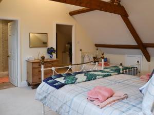 a bedroom with a bed with pink towels on it at The Old King's Head Pickering in Pickering