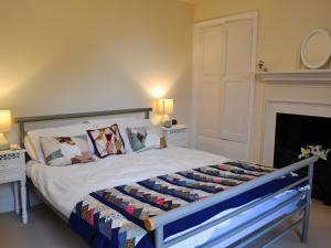 a bedroom with a bed with pillows and a fireplace at The Old King's Head Pickering in Pickering +8 photos