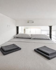 a large bed with two pillows on top of it at Apartment Nero in Izola