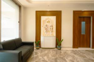 a living room with a couch and a door at Hotel Sitara Residency in Navi Mumbai