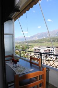 a table on a balcony with a view at Gjirokaster Mountain View Apartment in Gjirokastër