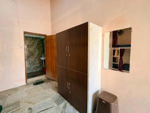 a room with a brown cabinet and a window at 5 Star Yatri Vishram AC & Non AC Dormitory in Jabalpur