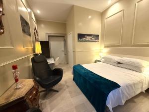 a bedroom with a bed and a chair and a desk at Spanish Steps Boutique Hotel - Madame Sofia Secret Hotel in Rome