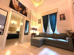a living room with a couch and a window at Spanish Steps Boutique Hotel - Madame Sofia Secret Hotel in Rome