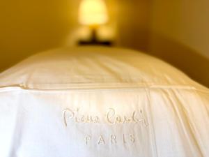 a bed with a white blanket with the name paulaugh paris on it at Spanish Steps Boutique Hotel - Madame Sofia Secret Hotel in Rome +3 photos