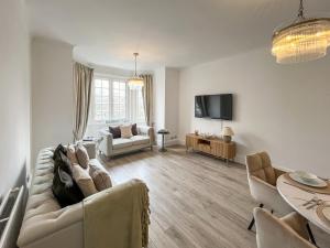 a living room with a couch and a tv at Joss Bay Days in Broadstairs