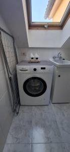 a washing machine in a bathroom with a sink at A&M Real Estate in Milladoiro