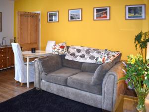 a living room with a couch and a table at Little Gubbs in West Buckland