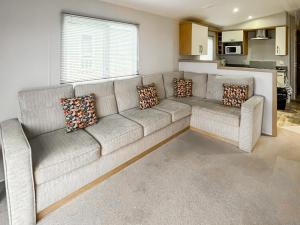 a white couch in a living room with pillows at The View in Stranraer