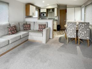 a living room with a couch and a table and chairs at The View in Stranraer