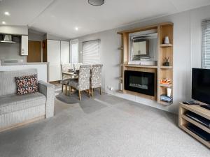 a living room with a couch a table and a television at The View in Stranraer +10 photos
