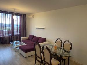 a living room with a couch and a table at Апартаменти Велека Бийч in Sinemorets