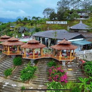 an image of a resort with tables and umbrellas at KDL Pauon Ecolakes in Quỳnh Nhai +12 photos