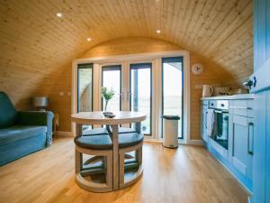 a small table in a room with a kitchen at Dougie's Pod in Acharacle