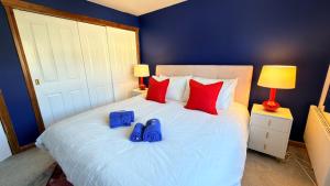 a bedroom with a bed with blue shoes on it at Super-King Room Tobermory with shared bathroom in Tobermory