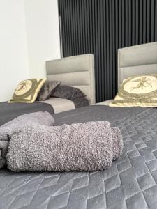 a blanket laying on a bed in a room at Apartman Velić in Bor
