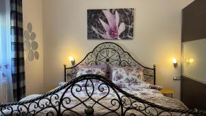 a bedroom with a bed with a metal headboard at Apartmani Hrastik 1 in Bihać