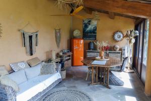 a living room with a couch and a table at Mas de l'Olivette in Cotignac