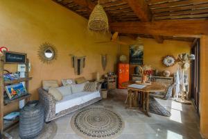 a living room with a couch and a table at Mas de l'Olivette in Cotignac