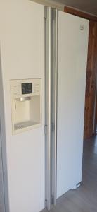 a white refrigerator in a room with a counter at Black Pearl in Höjaholm