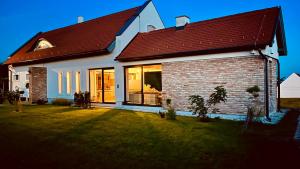 a white house with a red roof at Pannon Grace Balaton in Dörgicse