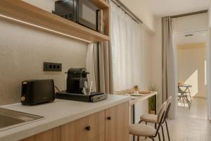 a kitchen with a coffee maker on a counter at Varvara's Diamond - Adults Only in Platanes +15 photos