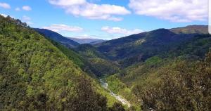 an aerial view of a valley in the mountains at Rêve de Plume in Beaumont +6 photos