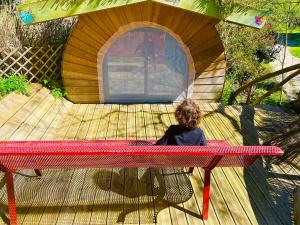 a child sitting on a table in a play house at Rêve de Plume in Beaumont