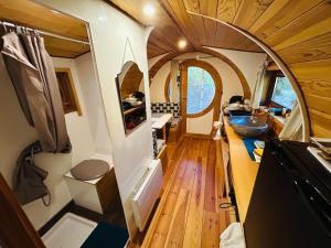 an interior view of an rv with a kitchen and a bathroom at Rêve de Plume in Beaumont