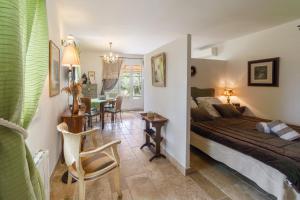 a bedroom with a bed and a table and chairs at Mas de l'Olivette in Cotignac +85 photos