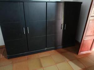 a black cabinet in a room with a tile floor at Quinta Campestre Bella Vista in Acacías