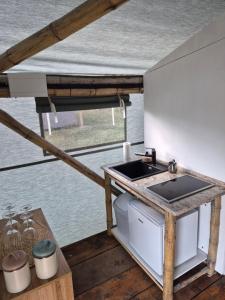 a kitchen with a stove and a sink on a boat at Bamboo glamping in Kotor