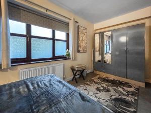 a bedroom with a bed and a large window at The Lade in Kilsyth +3 photos