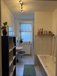 a bathroom with a tub and a sink at Dianas Ferienwohnung 2 in Feldberg +20 photos